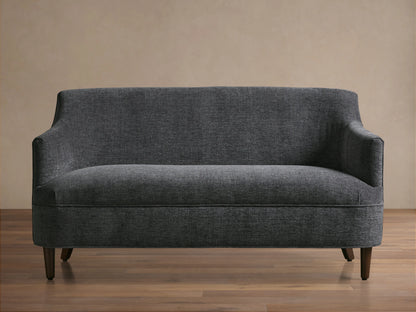 Dark gray textured Savannah Settee with curved back and arms, on dark tapered wood legs, centered against a neutral wall.