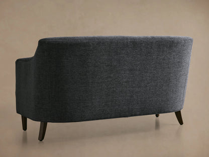 Savannah Settee, angled view from back-left, dark grey textured fabric, curved back and arm, with dark wood legs.