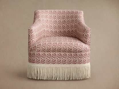 Savannah Swivel Chair with Fringe, pink & cream botanical pattern upholstery, cream fringe base, shown at an angle.