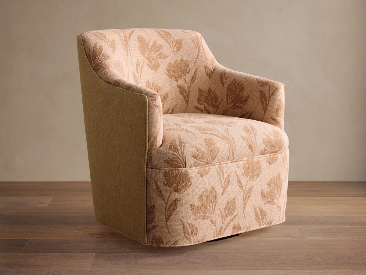 Savannah Swivel Chair in beige fabric with tan floral pattern, angled on wooden floor against neutral wall.