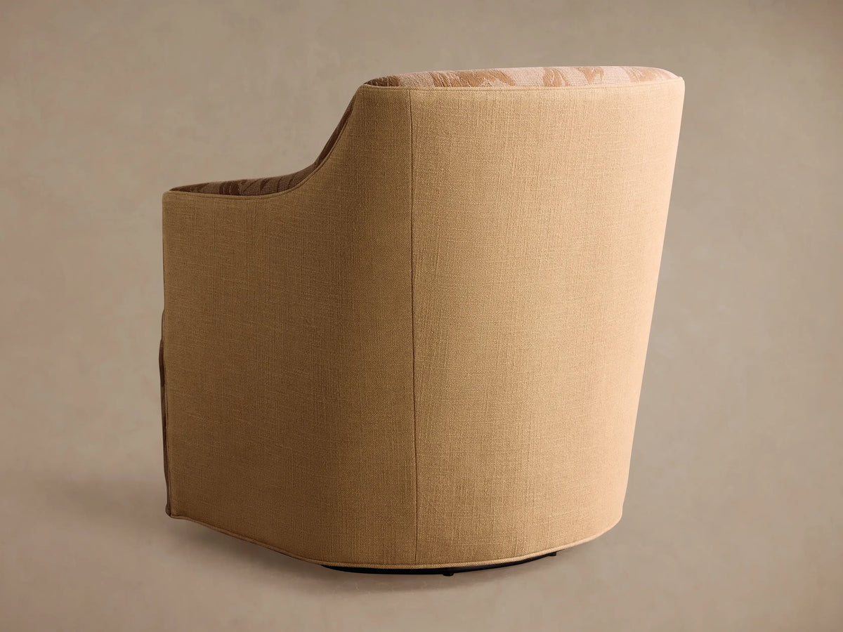 Close-up of Savannah Swivel Chair; beige textured fabric with brown floral & leaf pattern on plush seat, armrest, and back.
