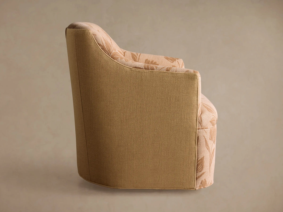 Savannah Swivel Chair, back view, angled left. Beige textured upholstery with a subtle light patterned fabric on the inner back/top.