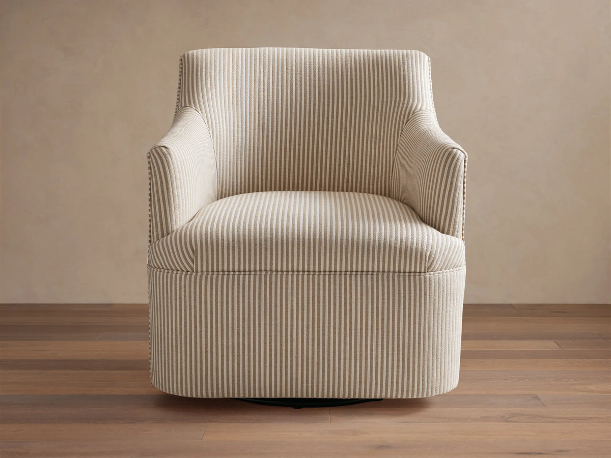 Upholstered Savannah Swivel Chair in light beige fabric with thin grey vertical stripes, angled on wood floor.