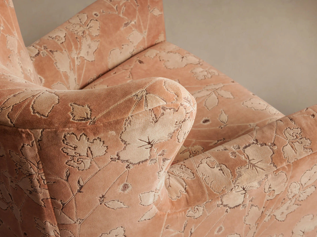 Front view of the Sasha Chair, upholstered in clay velvet with an intricate light floral and leaf pattern.