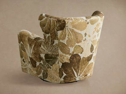 Sasha Swivel Chair featuring a botanical leaf pattern in shades of green and tan on a neutral background, viewed from the side.