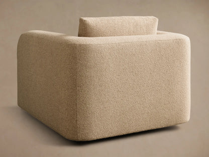 Side profile of a light beige textured Stiles Chair with rounded edges and a small back cushion.