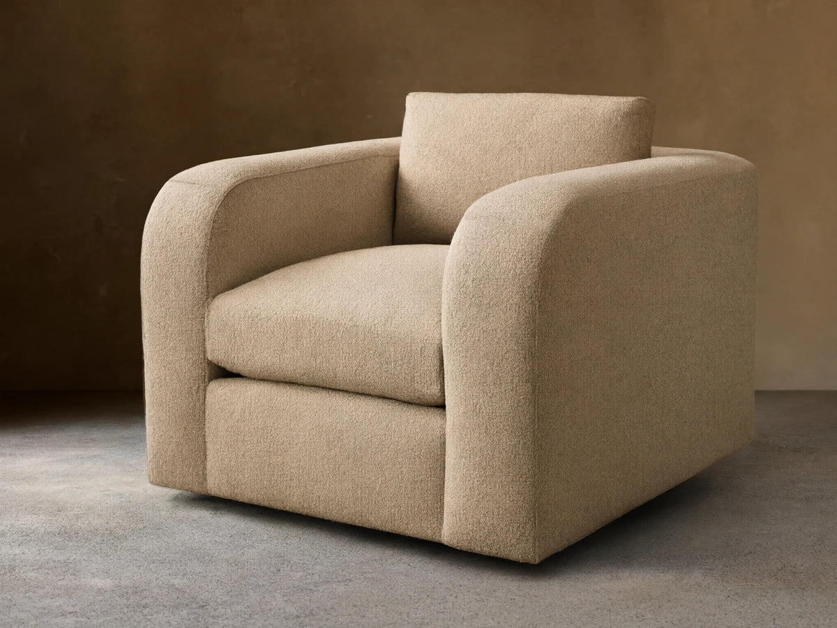 Front view of a plush, light beige textured Stiles Chair with rounded arms and a loose back cushion.