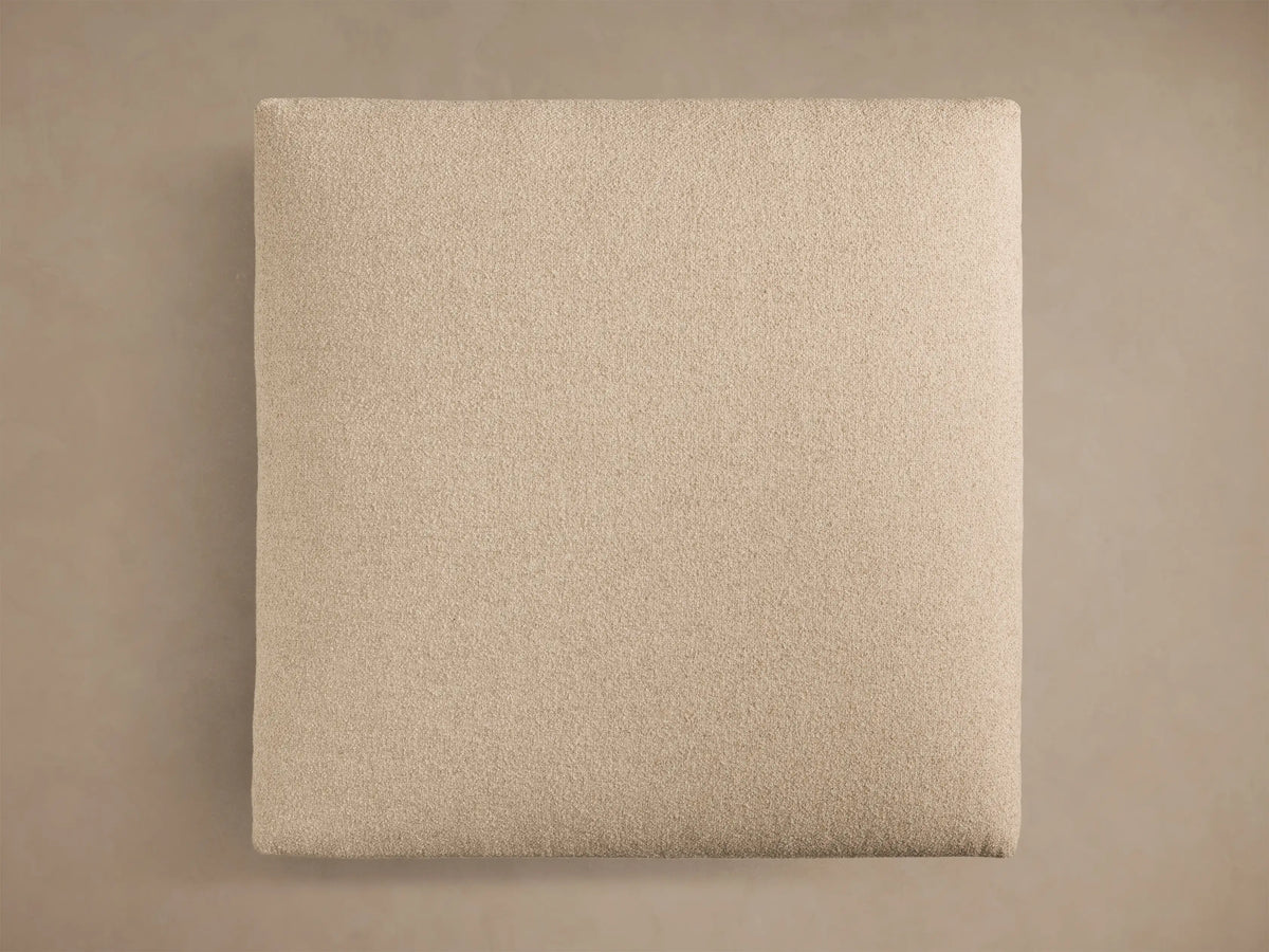 Top view of the square cream Stiles Ottoman. It features a textured fabric upholstery and soft, slightly rounded edges.