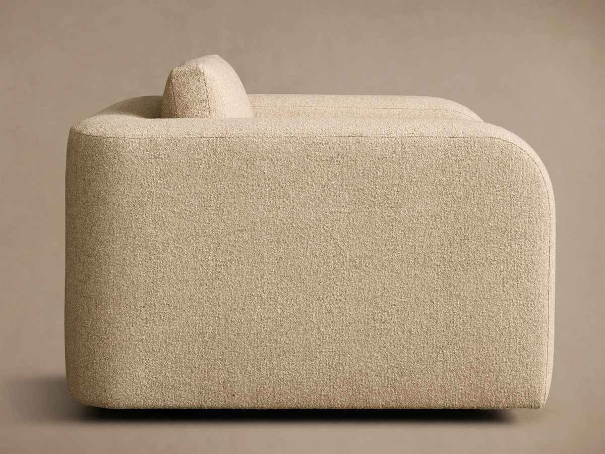 Front view of the beige textured Stiles Swivel Chair, featuring wide arms and separate seat and back cushions.