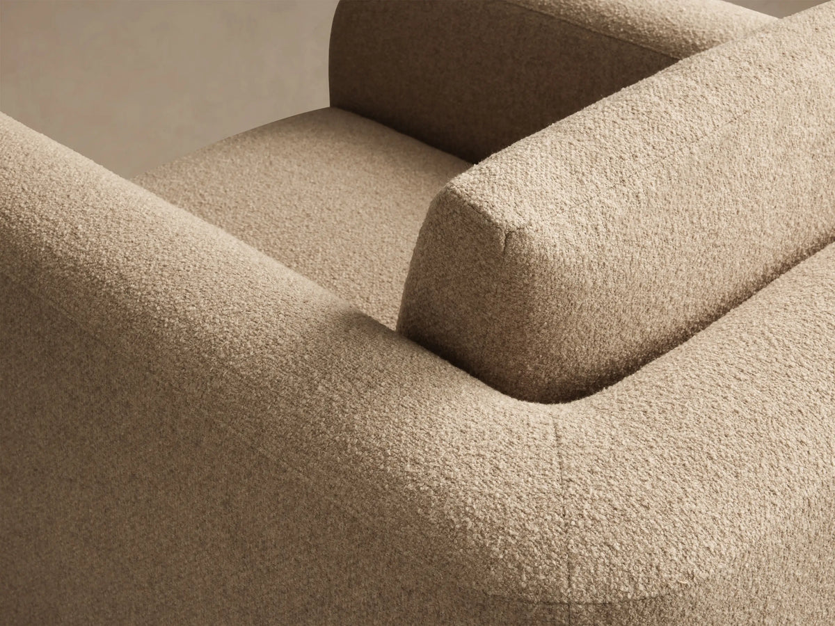 Side profile of cream Stiles Swivel Chair with rounded corners, textured fabric, and a small back cushion.