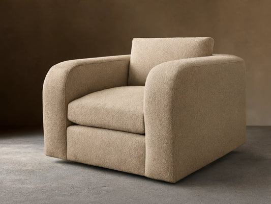 Front view of a beige Stiles Swivel Chair with rounded arms, a loose back cushion, and textured upholstery.