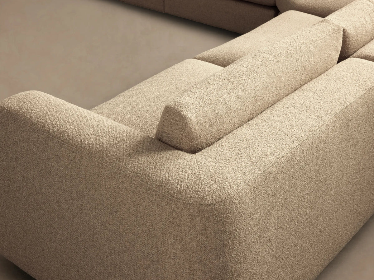 Front view of the light beige Stiles Five-Piece Sectional, arranged in a large, gentle curve with an ottoman.