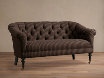 Tangier Settee in brown with white pinstripes, features curved arms and tufted backrest. Supported by wooden legs with casters.