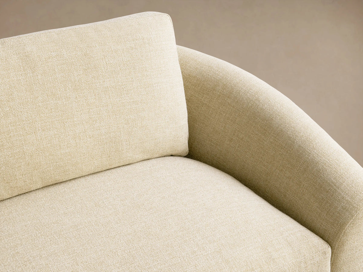 Avon Sofa: Light yellow/beige upholstered sofa with two seat cushions, two back cushions, and rounded arms, on a wooden floor.