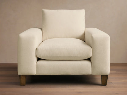 Cream Kipton Wide Arm Elevated Chair, angled front-right, featuring wide arms, plush cushions, and rich mocha wooden feet.