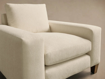 Front view of the off-white Kipton Wide Arm Elevated Chair with plush cushions and mocha finish feet.