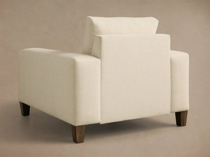 Front 3/4 view of the Cream Kipton Wide Arm Elevated Chair, showing wide arms, plush cushions, and a mocha-finished foot.