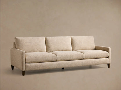 Front view of the beige textured Kipton Slim Arm Elevated Three-Cushion Sofa with dark mocha legs.