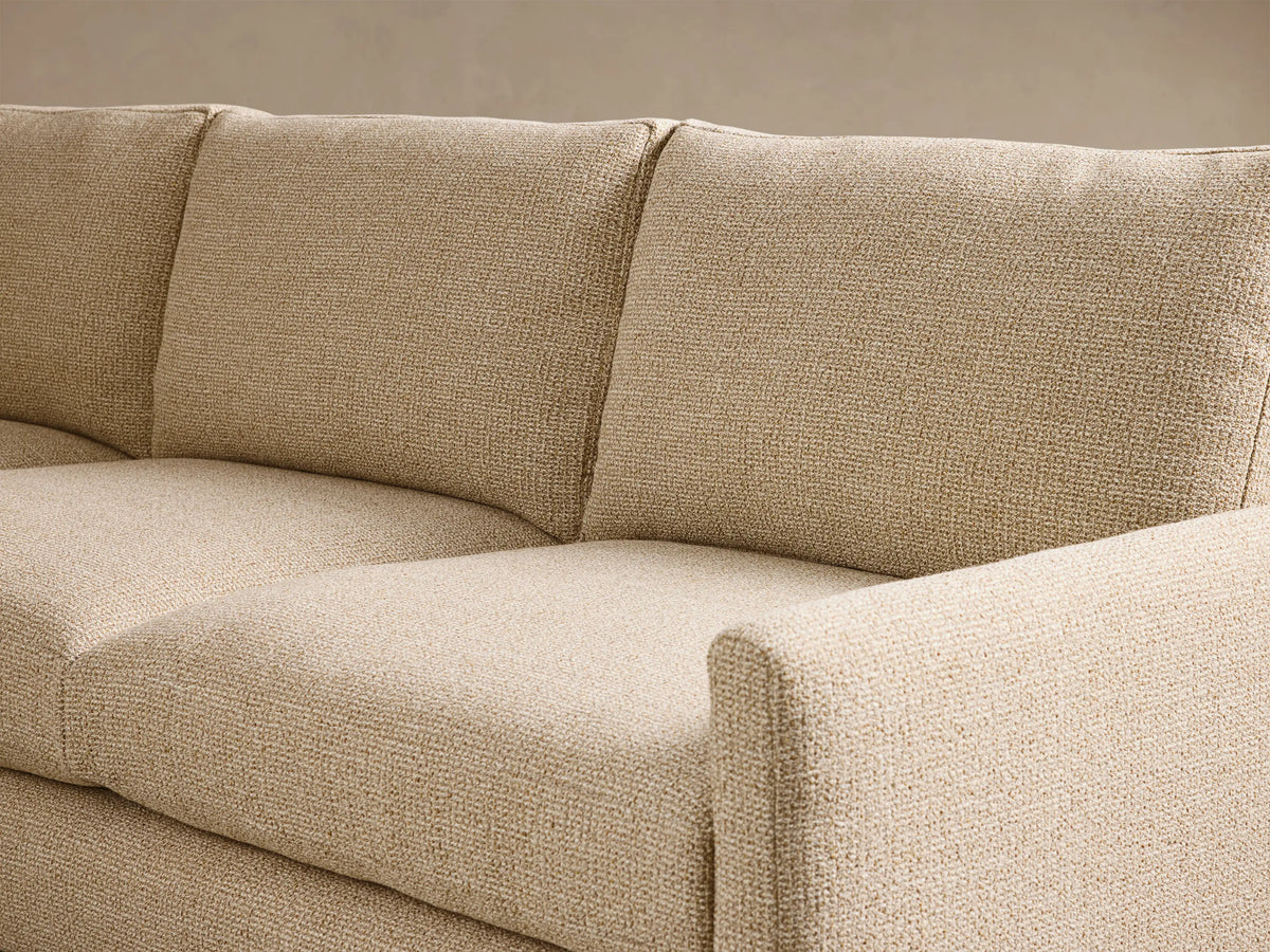 Close-up of the beige Kipton Slim Arm Elevated Three-Cushion Sofa, showing its textured fabric and slim arm.
