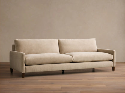 Front view of the beige Kipton Slim Arm Elevated Sofa with mocha finish feet.
