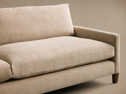 Light beige Kipton Slim Arm Elevated Sofa, angled view showing the woven fabric, slim arm, and dark elevated leg.