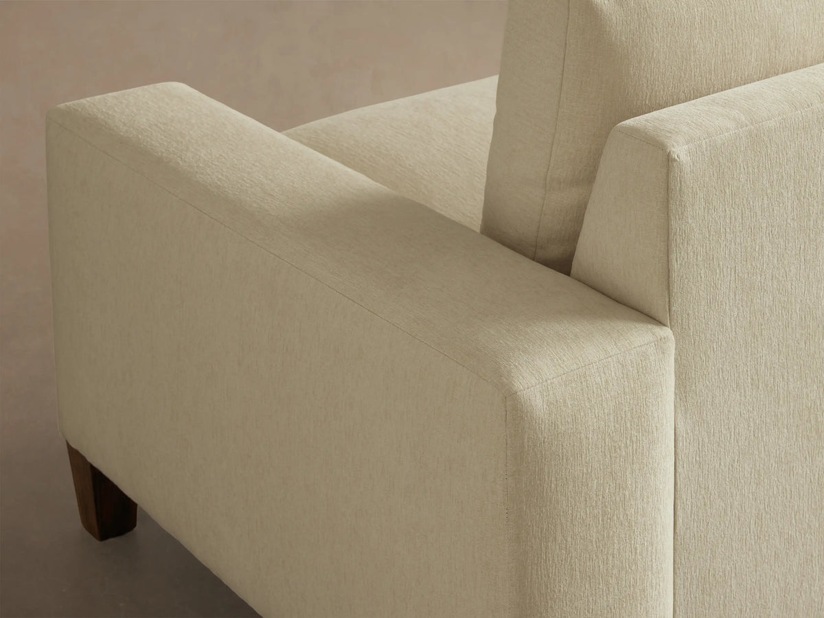 Front view of the Cream Kipton Wide Arm Elevated Sofa with two seat cushions, two back cushions, wide arms, and elevated mocha wooden feet.
