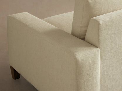 Front view of the Cream Kipton Wide Arm Elevated Sofa with two seat cushions, two back cushions, wide arms, and elevated mocha wooden feet.