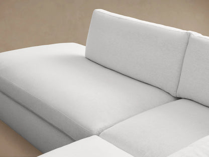Beale Two-Piece Bumper Sectional in light gray fabric, features a left-facing chaise and three-seat section with plush cushions.
