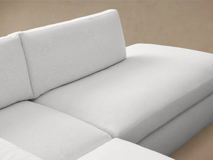 Beale Two-Piece Bumper Sectional in light gray fabric with left-arm corner seat and right-facing chaise, on wooden floor.