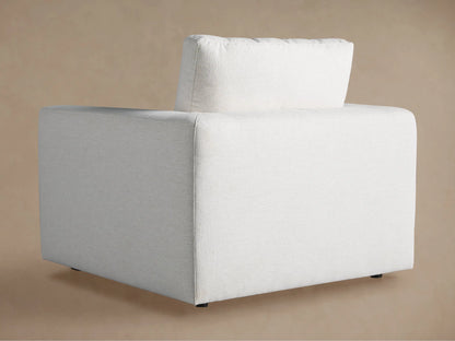 Light beige upholstered back cushion and armrest of the Beale Chair, showing textured fabric against a soft brown background.