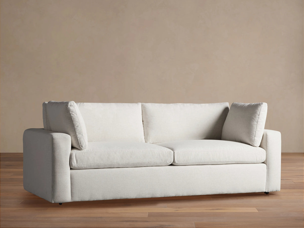 Front view of the oatmeal Beale Sofa, featuring two seat cushions, two back cushions, and two armrest pillows.