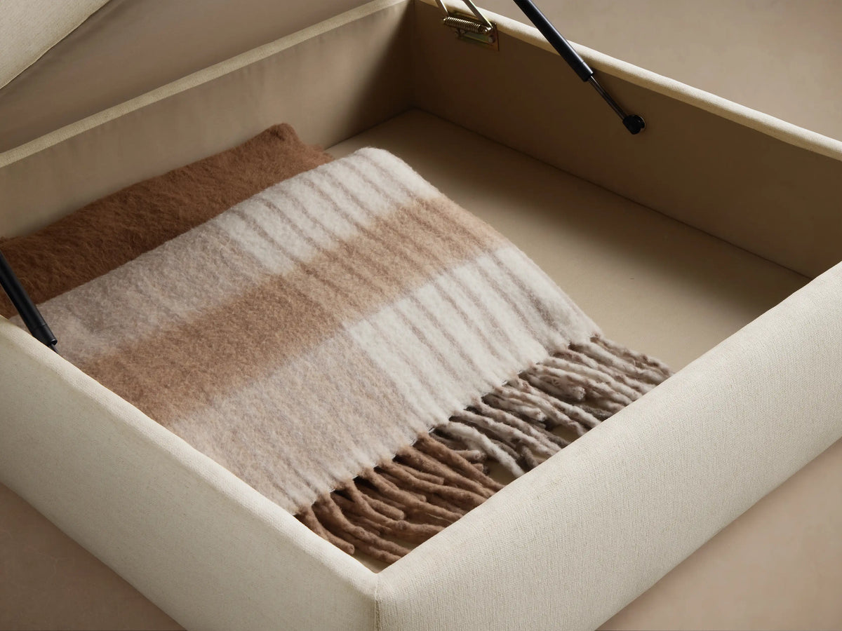 Close-up of the Cream woven upholstery fabric, showing the textured surface and a piped seam.