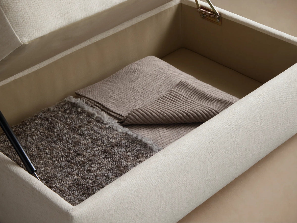 Close-up of the cream woven upholstery fabric on a cushion, showing a clean seam line.