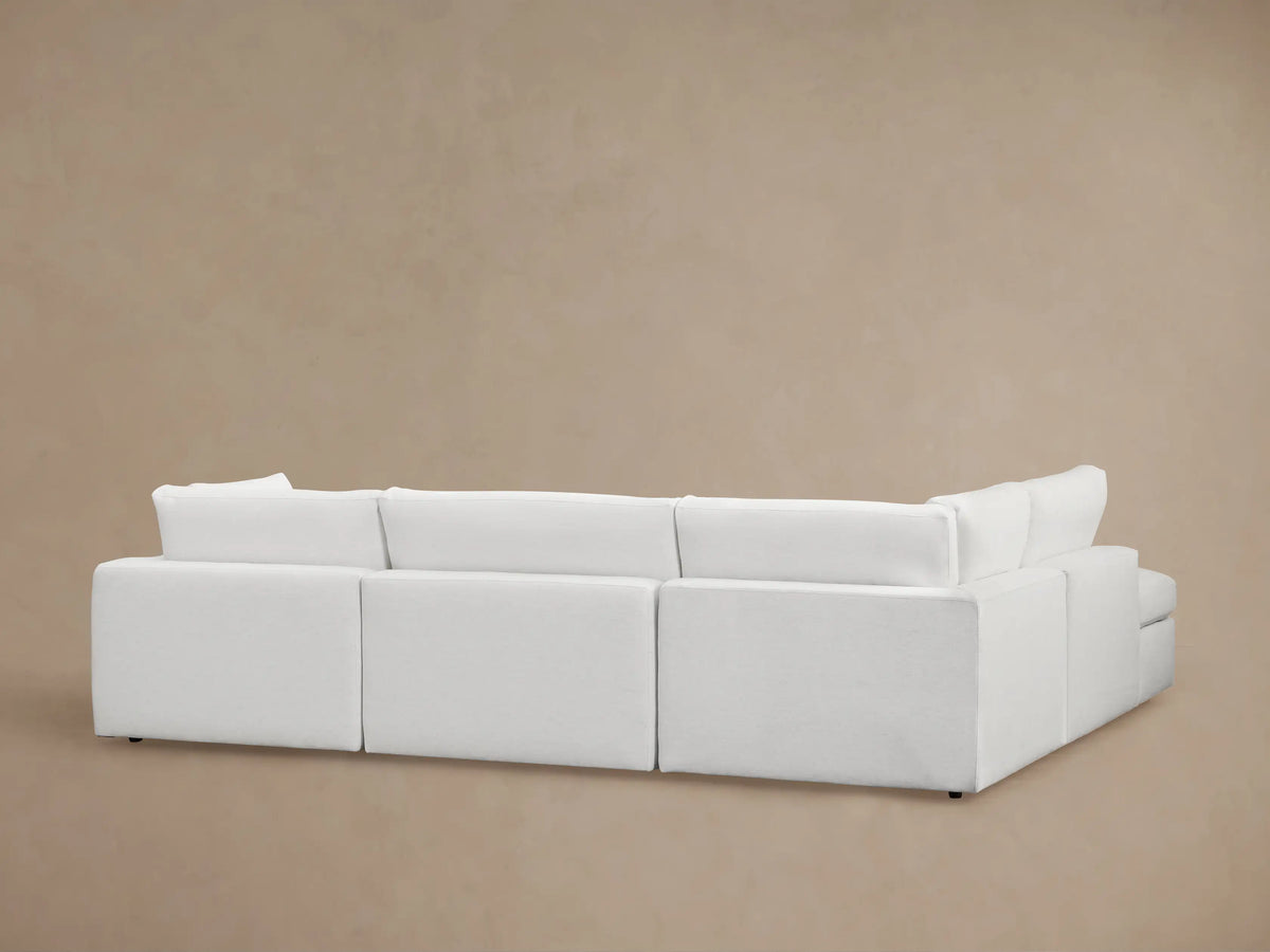 Beale Two-Piece Bumper Sectional shown in a light fabric with plush seat and back cushions, featuring a smooth, contemporary design and subtle fabric texture.