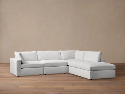 Beale Two-Piece Bumper Sectional in white fabric on wood floor, flat backrest with plush cushions, right-side chaise.