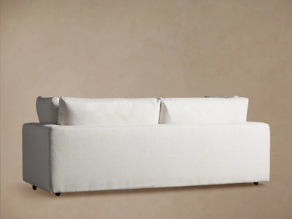 Close-up of the textured white Beale Sofa, showing its wide armrest, plush seat cushions, and back cushions from the right side.