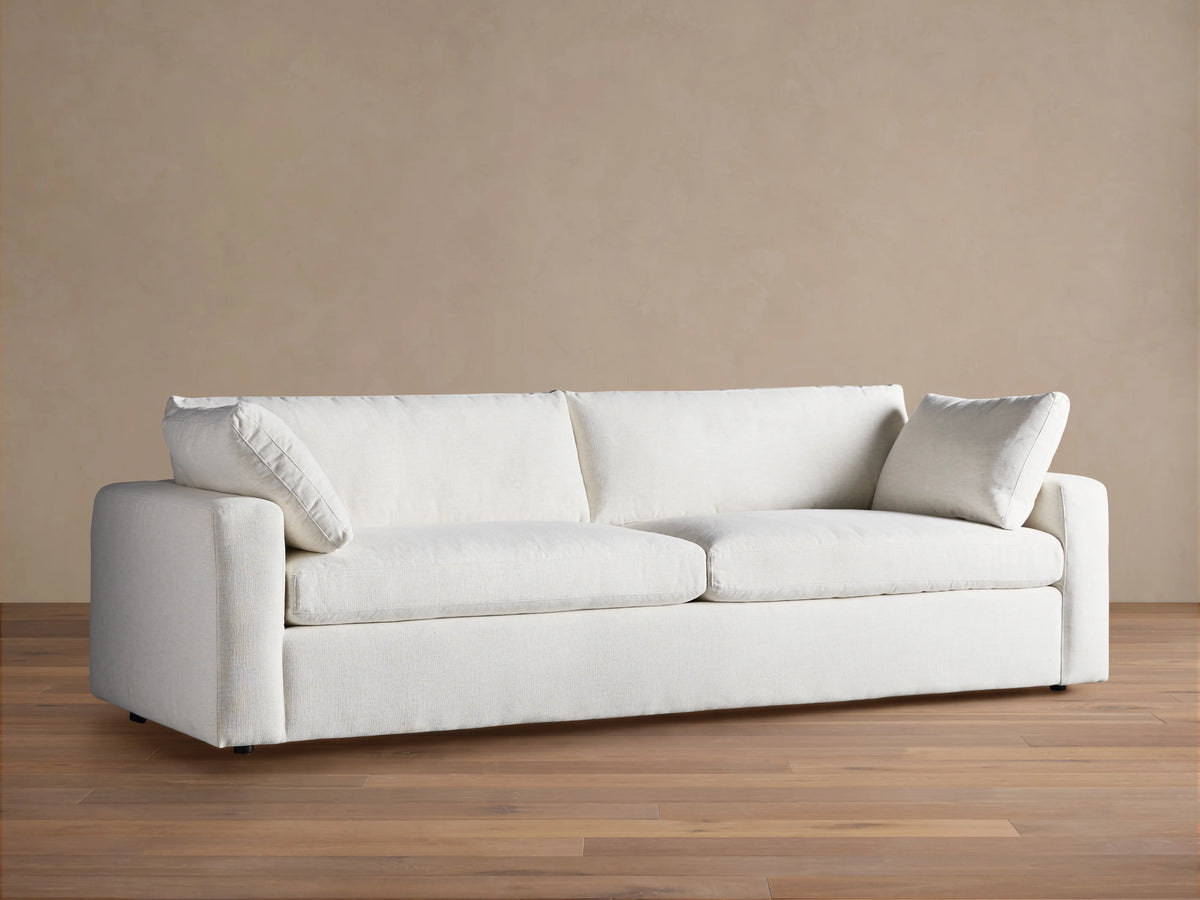 Front view of the light beige Beale Sofa with textured fabric, featuring two seat cushions, two back cushions, and two arm pillows.