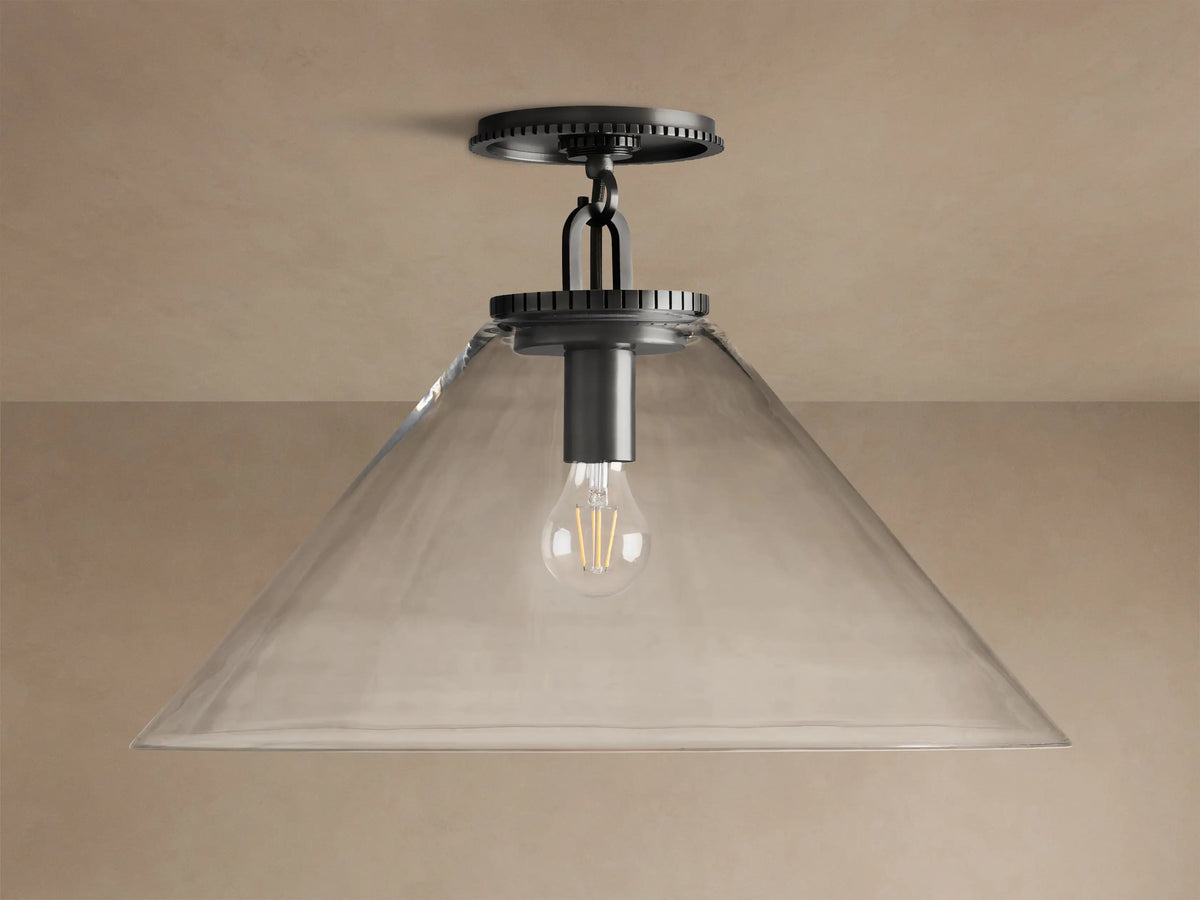 Wescott Cone Flush Mount with dark bronze hardware, clear glass cone shade, and visible Edison bulb, on a tan ceiling.