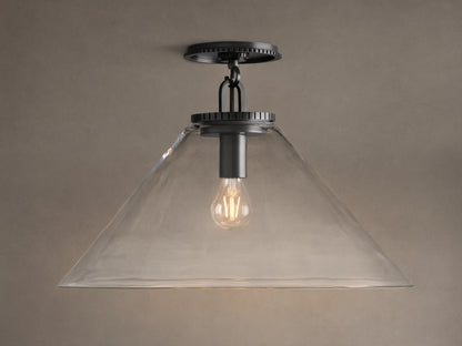 Wescott Cone Flush Mount with dark bronze hardware, clear glass cone shade, and visible Edison bulb, on a tan ceiling.