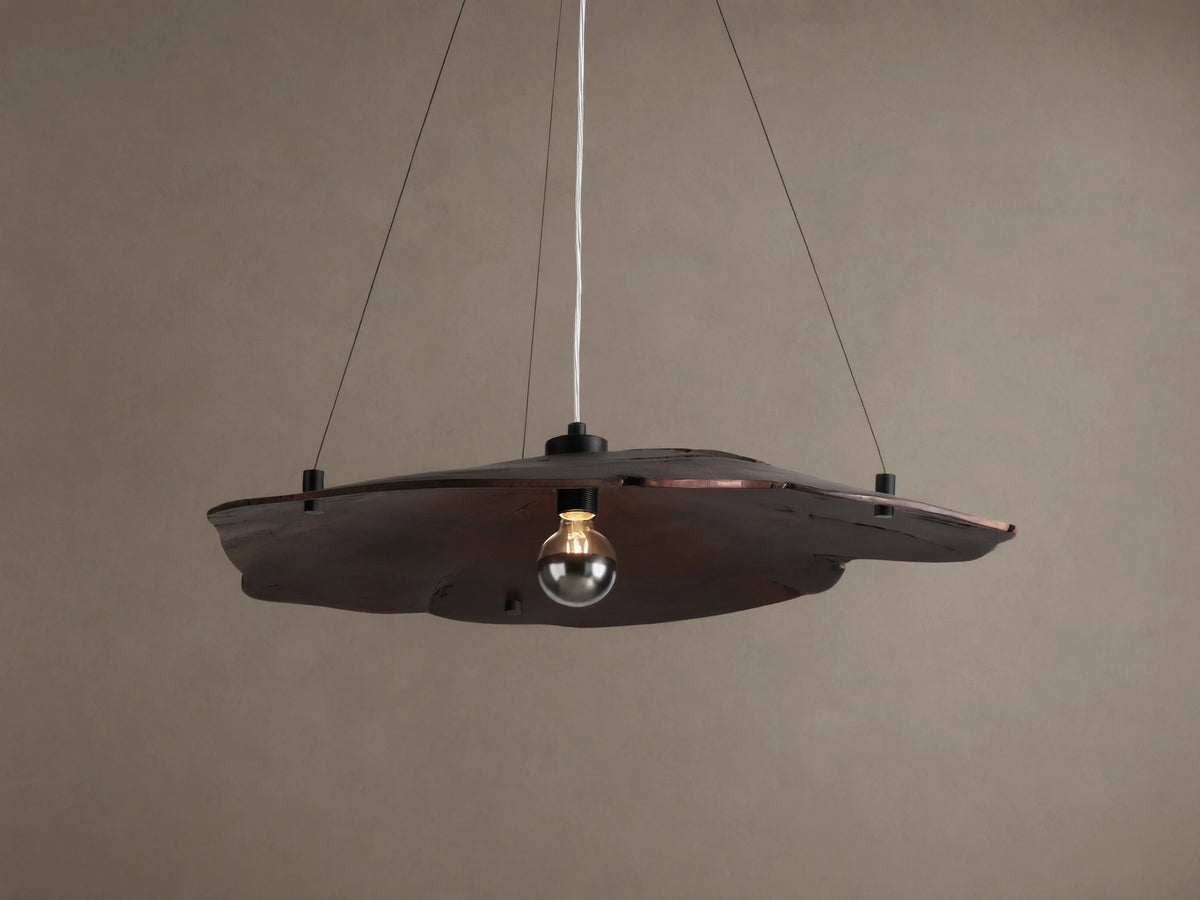Arruga Chandelier: Dark brown, organic milpa wood dome, suspended by black cables, with a softly glowing bulb.